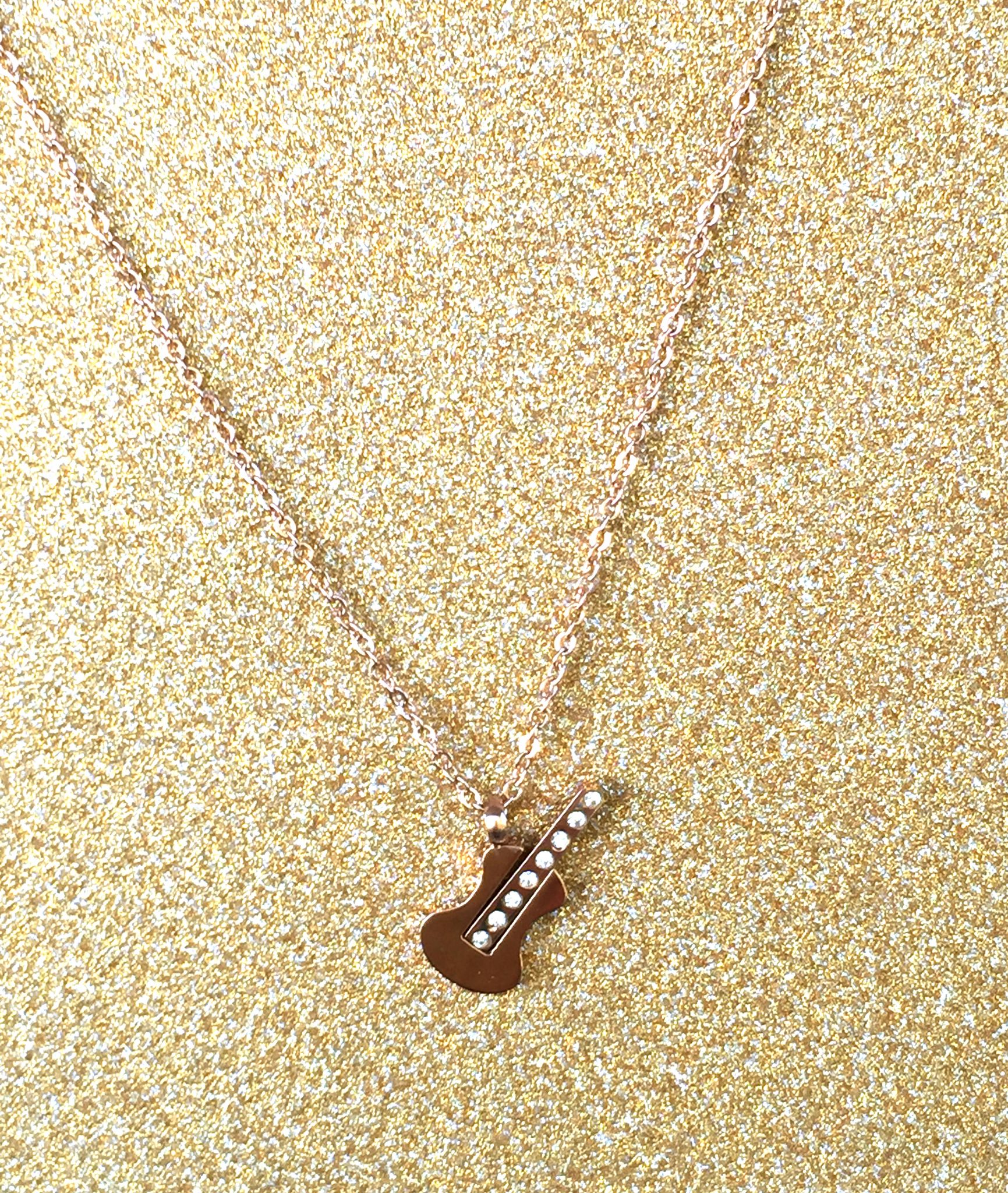 A beautiful butterfly pendant made of mother of pearl and emblazoned with small glittering crystals on a gold metal base. J020010